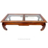 A large, Chinese, hardwood and bevelled glass panelled coffee table