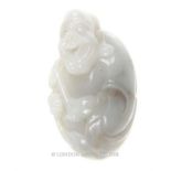 A Chinese, polished, white agate carving depicting a smiling sage