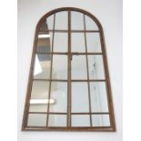 A large, arched topped, garden mirror with distressed metal work frame; 170cm high.