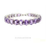 A substantial, sterling silver and faceted amethyst bracelet