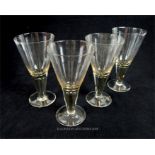 A set of four plain wine glasses of conical form