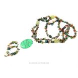 A long beaded necklace set with green agate beads and turquoise