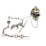 A silver Albert chain with a with a skull vesta case attached