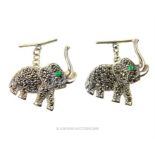 A pair of sterling silver cufflinks set with marcasite and emeralds