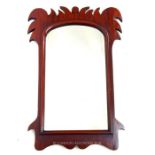 An antique, mahogany wall mirror