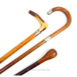 Two antique walking sticks with silver collars and a leather bound, swagger stick
