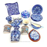 A collection of hand-painted, Persian-style ceramics