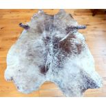 A large, natural cow-hide rug