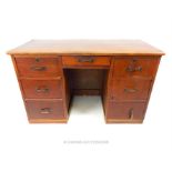 A 20th century, oak desk with brass handles