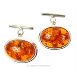 A pair of sterling silver and large, amber cabochon cufflinks