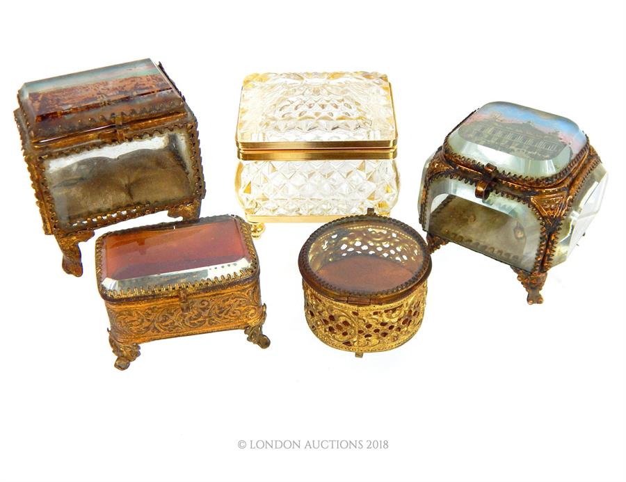 A collection of antique and modern, French, gilt metal and crystal caskets