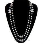 A Chanel-style, white freshwater pearl, and crystal monogrammed strand necklace