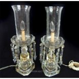 A pair of cut glass lustres with crystal storm lantern shades