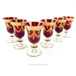 A set of sixteen, hand-blown, red, clear and gilt glass wine glasses