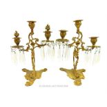 A pair of triple branch brass Rococo style candelabra