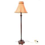 An early 20th century fruitwood standard lamp