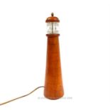 A turned, fruitwood and glass, lighthouse, lamp
