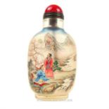 A Chinese, clear glass, reverse painted snuff bottle with red ceramic stopper