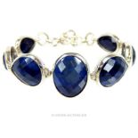A sterling silver and natural, faceted, sapphire bracelet