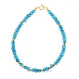 A boxed, 9 ct yellow gold and faceted, blue topaz bead and gold spacers bracelet