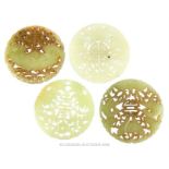 A collection of four Chinese carved jade discs
