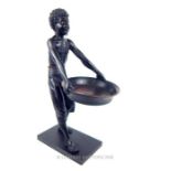 A 19th century carved wood, blackamoor figurine of a boy, with arms outstretched holding a tray;