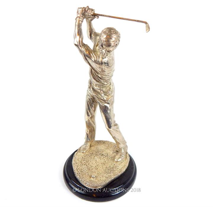 A silvered figure of a golfer