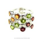 A sterling silver, four row ring set with garnets, peridots and citrines