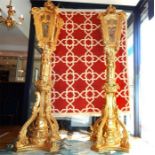 A pair of hand carved giltwood lamp posts