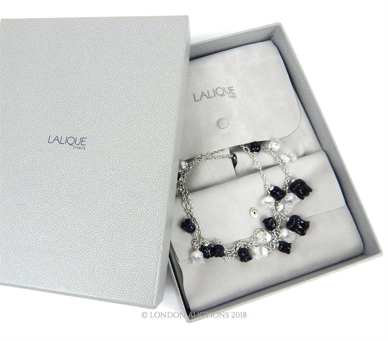 A boxed, Lalique, long, sterling silver, black and clear glass flower necklace