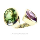 A chunky sterling silver ring set with a faceted, purple and green amethyst