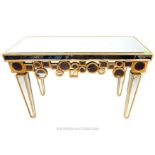 A contemporary console table formed of bevelled mirrored panels