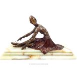 An Art Deco style bronze figure of a seated ballerina