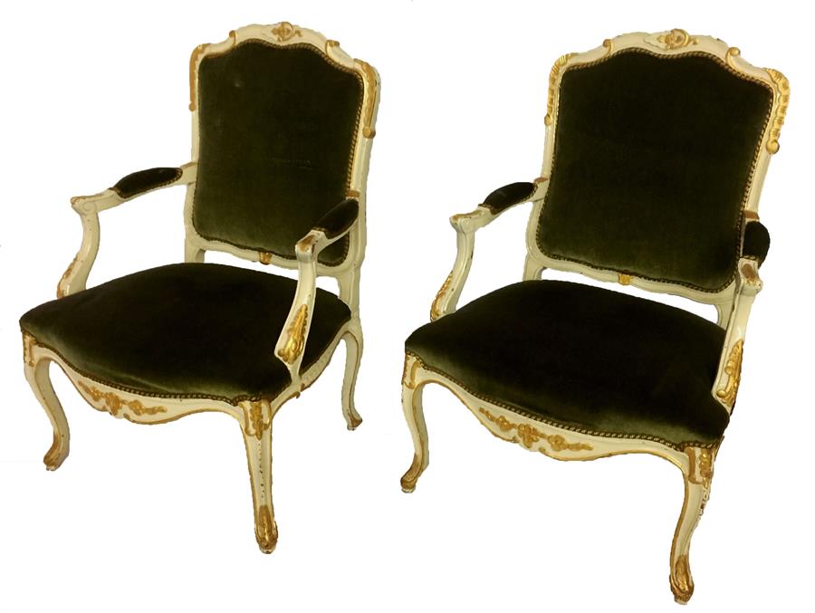 A pair of Louis XV, style, cream-painted, parcel gilt, open armchairs