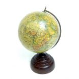 A vintage, small globe with stepped, brown-Bakelite base