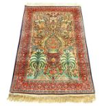 An Indian silk rug, having a tree of life design