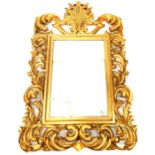 A large carved giltwood wall mirror