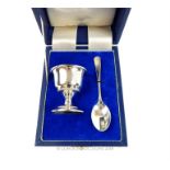 A cased, sterling silver egg cup and spoon