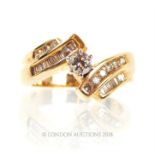 A 14 ct yellow gold cognac and white-coloured diamond cross-over ring