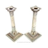 A pair of Edwardian sterling silver Corinthian column candlesticks