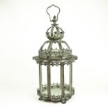 An ornate, metal, hanging lantern with hanging handle