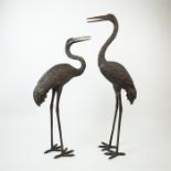 A pair of contemporary lifesize bronze sculptures of cranes