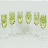 A set of six, hand-blown, engraved, green glass champagne flutes