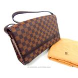 A Louis Vuitton, traditional, checkered, brown leather handbag