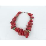 A necklace made of natural red coral and silver beads