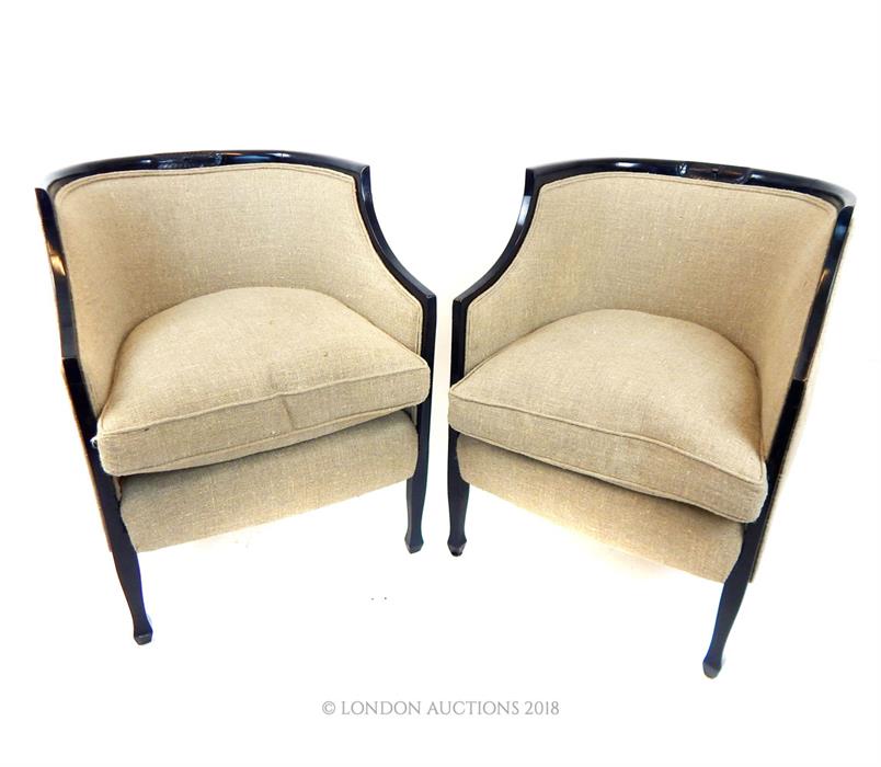 A matching pair of tub chairs with natural, linen upholstery