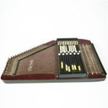 A vintage Auto Harp with burgundy lacquered finish