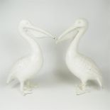 A pair of white painted cast iron figures of Pelicans