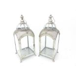 A pair of contemporary silvered storm lanterns