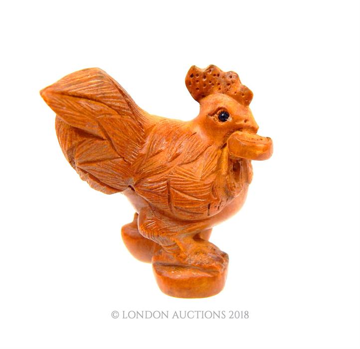 A Japanese wooden netsuke in the form of a cockerel